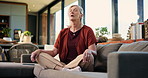 Senior woman, meditation and sofa with breathing exercise for inner peace or chakra in home. Elderly, female person or relax with zen on couch for health, spiritual wellness or mindfulness in house