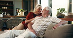 Senior couple, talk and laugh on sofa for bonding, love and care with funny story in lounge at house. Elderly man, woman and chat with happy memory, discussion or relax on couch in retirement home