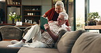 Tablet, happy and senior couple on sofa with planning for retirement vacation together in home. Conversation, digital technology and elderly people in living room with booking flight tickets in house