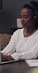 Remote work from home, laptop and black woman with headphones, internet and deadline for article. African person, copywriting and freelancer with pc, audio and research for news report or editing