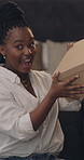 Black woman, influencer and ring light in home, unboxing or shake with review for online audience. African person, cardboard package and presenter on social media, live stream or mystery for video