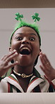 Black woman, face and surprise with box for saint patricks day, gift or delivery below in home. Low angle, portrait or female person with shock or wow for cargo, parcel or secret package in Ireland