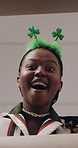 Black woman, face and surprise with open box for saint patricks day, gift or delivery below in home. Low angle, portrait or female person with shock for cargo, parcel or secret package in Ireland