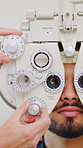 Eye test, man and hands of optometrist with phoropter for vision, checkup and eyesight assessment. Exam, machine and person with ophthalmologist for health, visual wellness or consultation in clinic