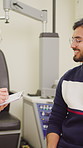 Man, optometrist and writing notes for consultation, smile or report for eye test, glasses or results. Ophthalmologist, people and review with clipboard, vision exam and optic wellness at clinic