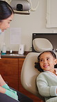 Woman, dentist and happy with girl, consultation and listen with oral health advice at clinic. People, child patient and talk for dental wellness, inspection or smile with discussion at hospital