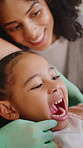 Woman, dentist and girl with open mouth, inspection and mom for oral health exam at clinic. People, child patient and dental expert with check, hygiene and wellness with consultation at hospital