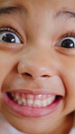 Face, surprise and teeth of little girl in reaction to anticipation, excitement or good news. Children, energy and smile with wow facial expression of kid closeup for optimism or satisfaction
