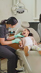 Dentist, mother or child with inspection for mouth assessment, oral exam or speaking in office. Dental care, girl or tooth specialist with instructions for cavity check, parent or medical appointment