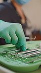Hand, oral health or dentist in office, tools or gloves for hygiene, wellness or woman. Closeup, medial excavator or person in clinic, dental ball burnisher or equipment for procedure or orthodontist