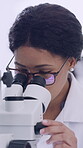 Scientist, analysis and woman with microscope, lab and medical research of cancer cells with glasses. Healthcare, pathology and person with equipment for disease diagnosis and biotechnology for cure