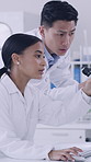 Computer, scientist and team with discussion in lab for experiment, innovation or microbiology. Research, science and planning with people on tech for medical test, typing or pointing with microscope