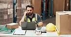 Laptop, logistics and phone call with man at desk in warehouse for distribution or shipping update. Computer, conversation and supply chain with person in storage depot for agenda or schedule