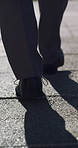 Shoes, walking and business person in city for travel, morning commute and lawyer on urban journey. Feet, street and professional outdoor on trip with back, pedestrian and legs of attorney on road
