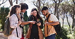 Friends, phone and lost in forest on hiking adventure, talk and problem solving for direction on vacation. Woman, group and smartphone with point, confused or search map with mobile app for trekking