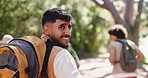 Man, face and backpacking with group, forest and happy for adventure in nature, walking and holiday. Outdoor, hiking and person with friends on journey, tourism and sightseeing on vacation or trip