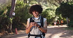 Phone, backpacking and man in nature for hiking on vacation, getaway or weekend trip with texting. Outdoor, cellphone and male person with trekking blog on mobile app for exploring trip in woods.