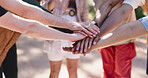 Teamwork, hands and stack with people outdoor for motivation, collaboration and support for hike. Friends, huddle and together with solidarity for exercise, wellness and bonding in nature for travel