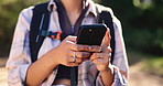 Phone, backpacking and hands of woman in nature for hiking on vacation, getaway or weekend trip. Outdoor, cellphone and female person with trekking blog on mobile app for exploring trip in woods.
