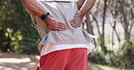 Outdoor, hands and hiker with back pain, hurt and massage for spine injury in forest or inflammation. Traveler, sore and person with muscle strain, health and accident on vacation in nature and trip