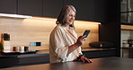 Phone, smile and senior woman in kitchen in home with social media, connectivity or texting. Happy, technology and elderly female person with cellphone for chatting on mobile app in apartment.