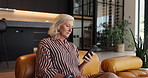 Phone, reading and senior woman on sofa in home with social media, connectivity or texting. Serious, technology and elderly female person with cellphone for chatting on mobile app in apartment.