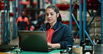 Logistics, woman and typing in warehouse with laptop for idea, shipping and distribution report. Happy, person and reading with computer in factory for operations email, supply chain review and plan.