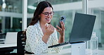 Woman, phone and smile with texting at office, notification and laptop at investment company. Person, financial advisor and broker for online consulting, glasses or happy with mobile app at agency