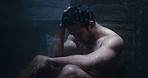 Sad, depressed and man in shower thinking for disappointment, failure and crisis. Bathroom, dark and person with thoughtful, reflection and mistake for mental health, burnout and frustrated in home