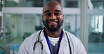 Face, doctor and black man in clinic, smile and confidence with wellness, medical service and pride. African person, employee or professional in hospital, career ambition or physician with healthcare