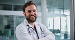 Face, happy man and doctor in hospital with arms crossed for medical service, patient support and help. Confident, person and healthcare worker in clinic with smile, career development and about us.