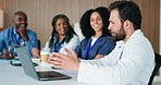 Man, talking and doctors in meeting, laptop or feedback for hospital compliance. People, medical service or review for clinical trial, discussion or email for research funding, internet or healthcare