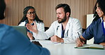 Man, discussion and doctors in meeting, healthcare and feedback for hospital schedule. People, medical service and employees in clinic, agenda or review for medicare support and time management