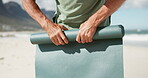 Hands, roll and person with mat, beach and finished with routine for wellness and done with workout. Complete, activity and packing up after exercise with equipment, outdoor and fitness in nature