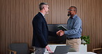 Handshake, smile and men in office with technology, collaboration and meeting for b2b deal. Tablet, laptop and employees in agency with shaking hands, agreement and shared opportunity for success.