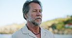 Breathing, calm and mature man on beach with relax, vacation or zen for self care in morning on holiday. Wellness, travel and male person with fresh air or breeze by ocean for peace on weekend trip.
