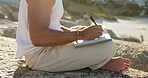 Man, hands and writing by ocean with journal for goal setting, personal growth or process emotions. Daily reflection, notes or person at beach with diary for self improvement, inspiration or insight.