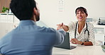 Doctor, patient or shaking hands in office with laptop, health insurance agreement or discussion. Handshake, healthcare worker or people with computer for medical aid approval, greeting or thank you.