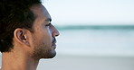 Thinking, relax and man on beach for calm, mindfulness and peaceful in fresh air for wellness. Nature, inspiration and person by sea, ocean and outdoor with reflection, thoughtful and perspective