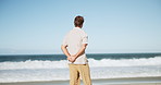 Thinking, relax and back of man on beach for calm, mindfulness and peaceful in fresh air. Nature, inspiration and person by sea, ocean and waves outdoor with reflection, thoughtful and wellness
