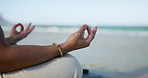 Person, hands and beach with meditation for spiritual wellness, chakra or zen on ocean coast. Closeup, yoga or inner peace with lotus pose, mudra or mantra for mindfulness or calm balance in nature