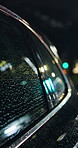 Night, car and window in city with rain weather, driving and transportation for luxury taxi service. Bokeh, vehicle and travel outdoor in urban town with water droplets, cold evening and premium cab.