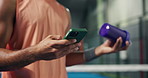 Phone, protein shake and hands of man on padel court with networking, social media or contact. Technology, fitness drink and person with cellphone for texting on mobile app at indoor sports center.