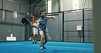 People, playing and padel games on court for fitness, match practice and swing technique. Athlete, men or hitting ball with racket for sports challenge, tennis competition and teamwork for tournament