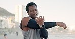 Black man, fitness or stretching with arms on promenade for workout preparation or outdoor exercise. Active, male person or runner with warm up for flexibility, training or physical activity by beach