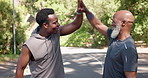 Coach, black men and smart watch with high five outdoor for success, fitness progress and achievement. Senior person, trainer and check time for performance, monitor exercise and celebration of race