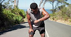 Running, tired and black man in city with time for exercise, fitness and marathon training outdoor. Sports, fatigue and person with wrist watch for workout performance, wellness and health on road