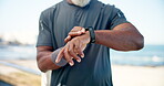 Hands, old man and smart watch for fitness at beach for heart rate, exercise and monitor progress. Senior person, check and wristwatch for time, tracking performance and training results for wellness