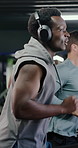 Fitness man, running and treadmill with headphones in gym for workout or cardio exercise. Active, male person or runner with smile, music or sound for indoor training or weightloss in health club
