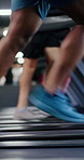 Shoes, fitness and treadmill with group at gym, motion blur or speed training at running class. People, machine and legs with equipment, cardio workout and exercise with challenge at wellness club
